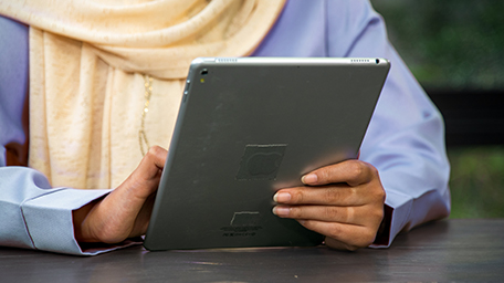 Women on tablet scrolling through tools and guidance