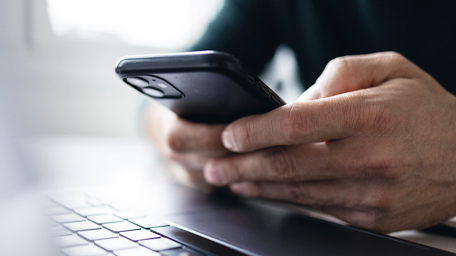 Close up on man hand using mobile phone