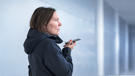 Casual woman using mobile phone for communication outdoors on the street