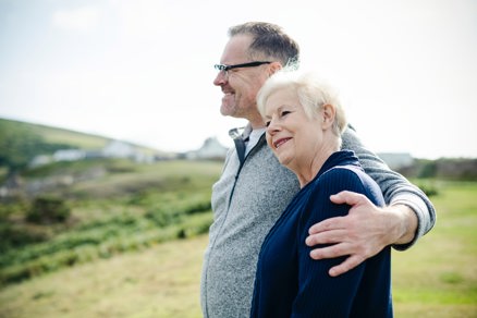 Older couple smiling in the countryside