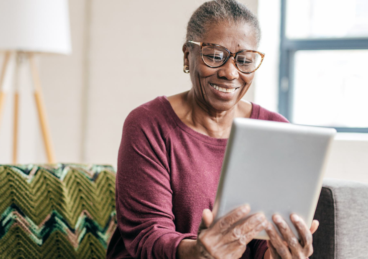 woman-smiling-looking-at-tablet